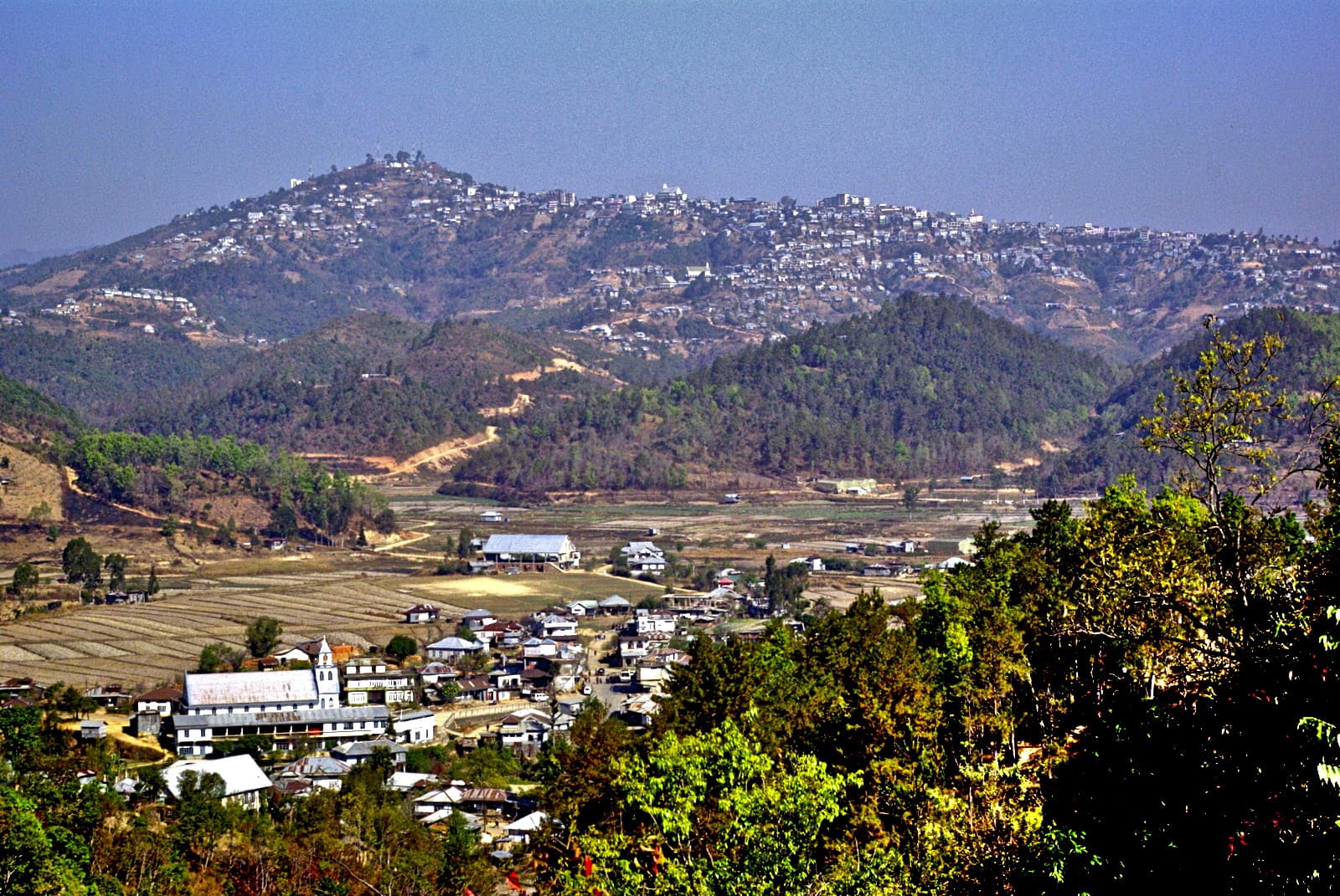 Champhai town on its hillside above harvested paddy terraces